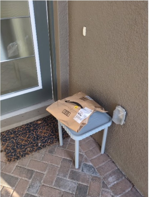 An Amazon package resting on the PorchDrop table